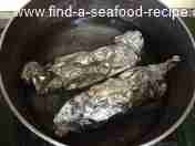 putting prepared salmon into a pan of water