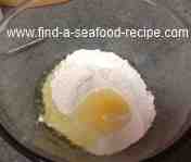 Egg broken into flour