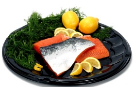 Fresh Salmon fillet on black plate