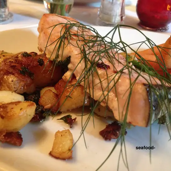 swordfish steak on a plate with vegetables