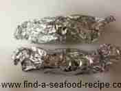 salmon wrapped in foil ready to be put in the pan