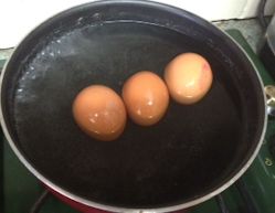 whole eggs in a pan of water whole eggs in a pan of water
