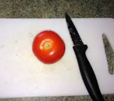 tomato on chopping board tomato on chopping board